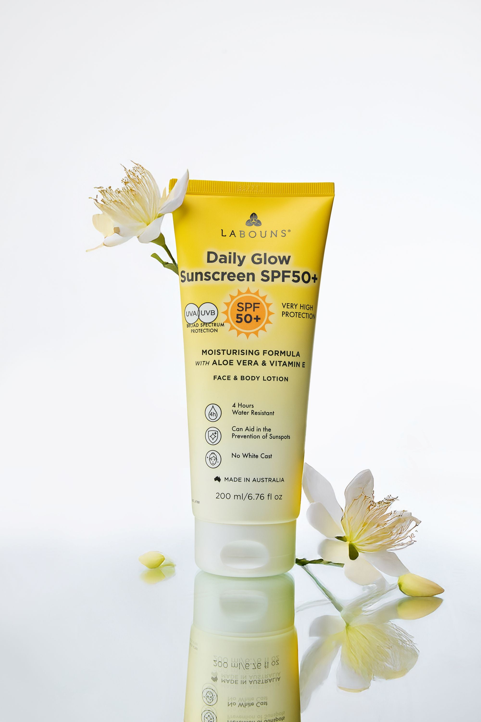 Tube of Labouns Daily Glow Sunscreen SPF50+ on a white background with flowers.