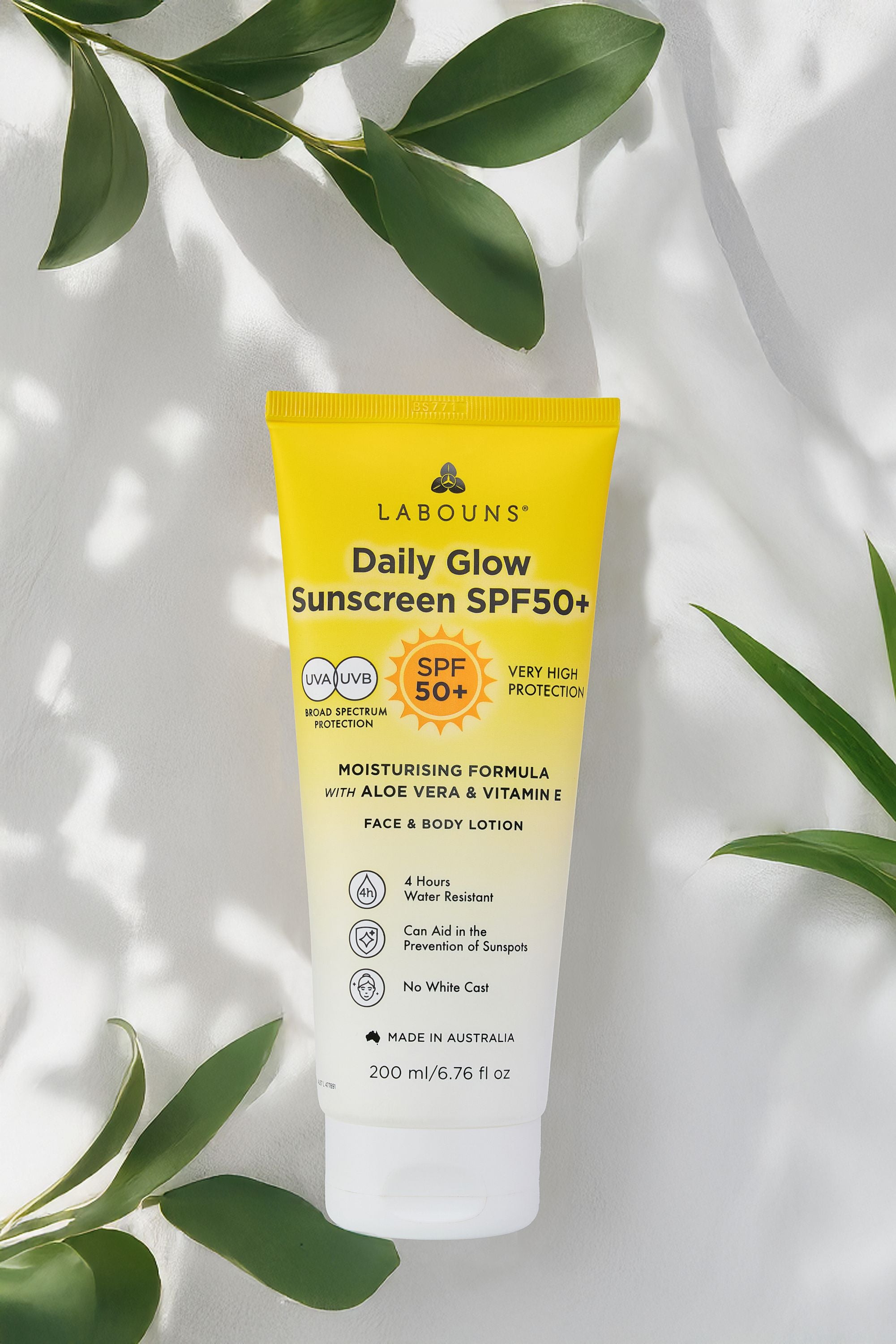 Labouns Daily Glow Sunscreen SPF50+ on a light background with green leaves.
