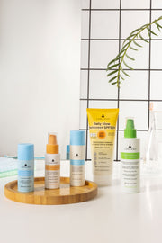 Collection of Labouns skincare products on a tray with a white background and plant decoration