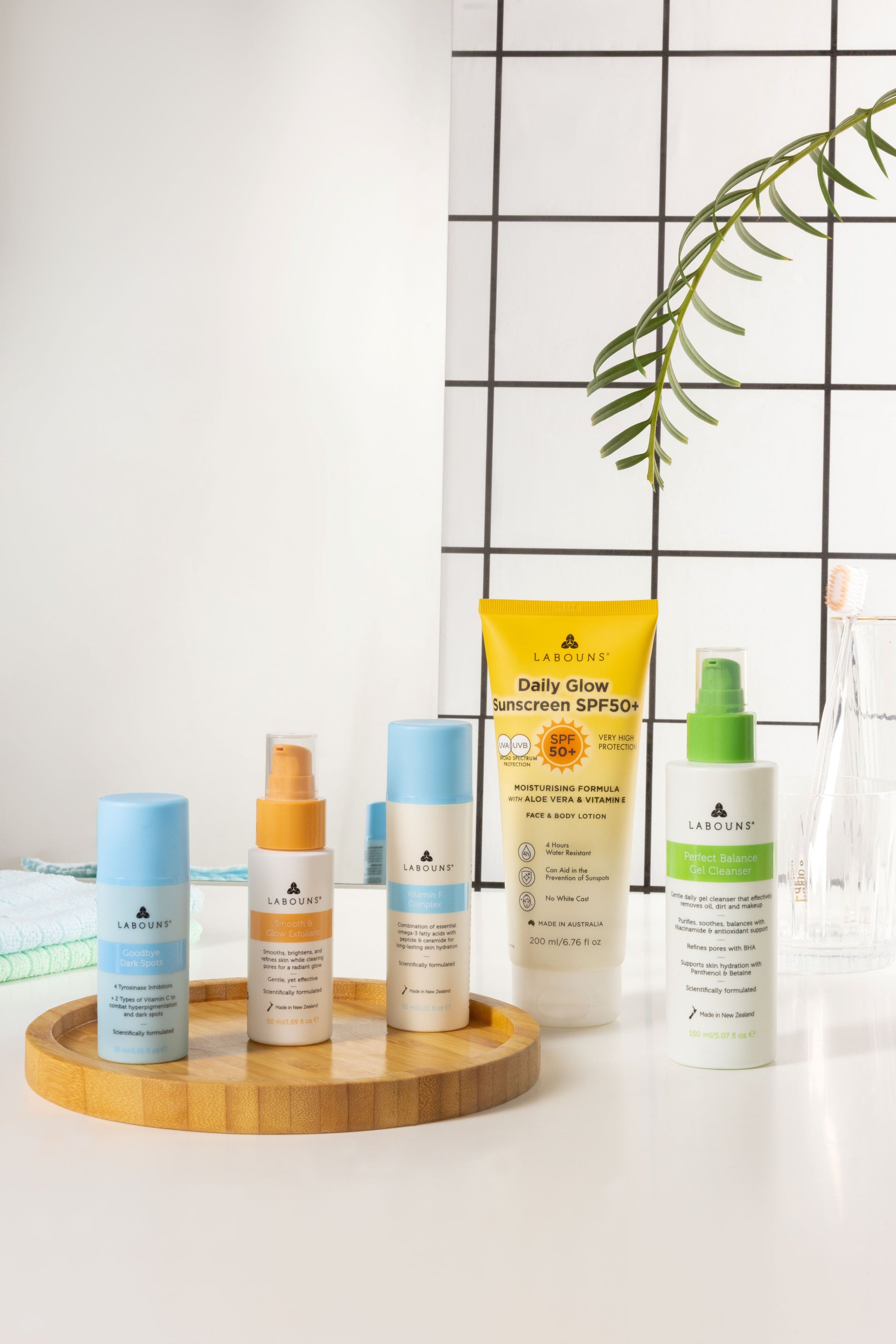 Collection of Labouns skincare products on a tray with a white background and plant decoration