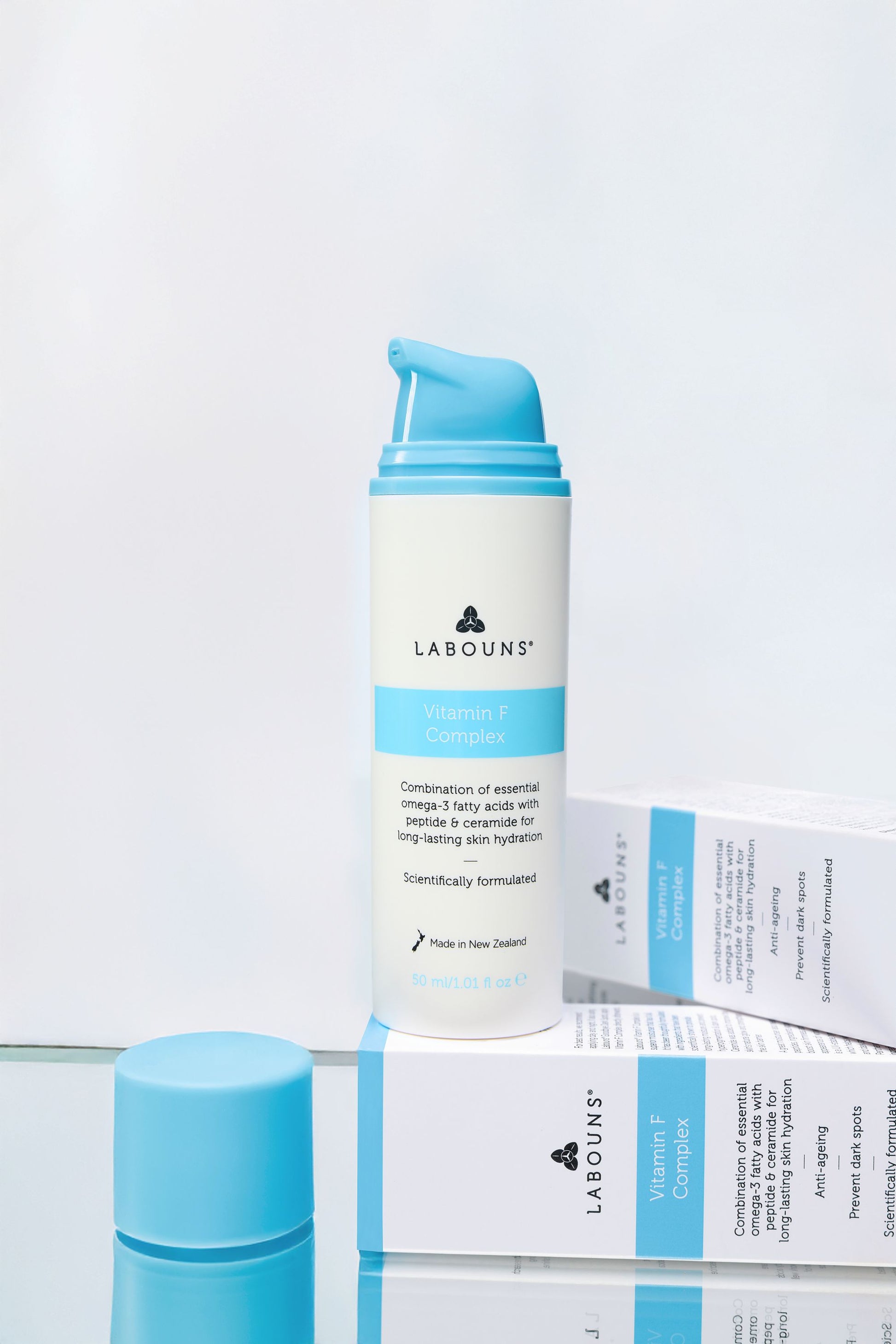 Skincare product with blue and white packaging on a light gray background