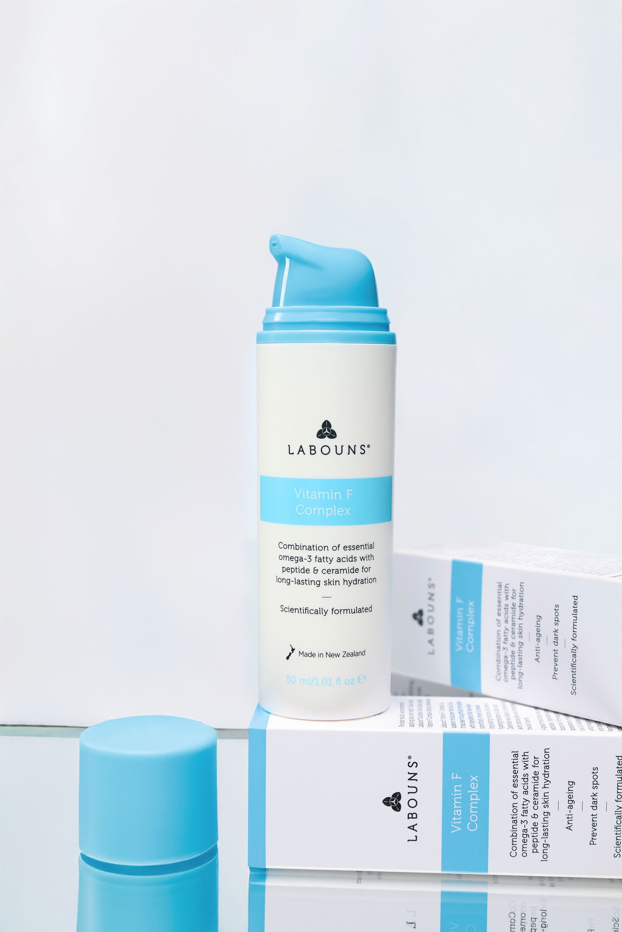 Skincare product with blue and white packaging on a light gray background